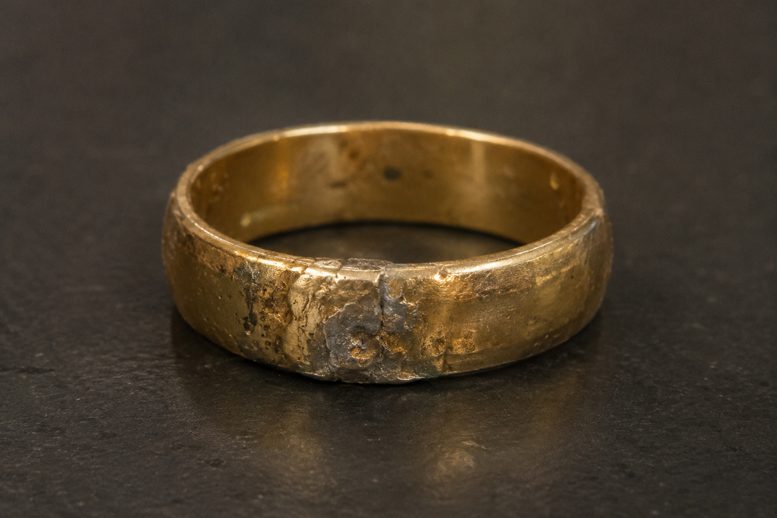 a botched solder joint on a gold ring to perform a structural repair salvage at Motek Jewelry Design Studio in Airmont, NY.