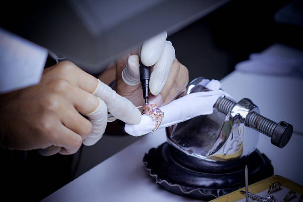 Master jeweler at Motek Jewelry in Airmont NY repairing a ring and setting a diamond in a rose gold ring
