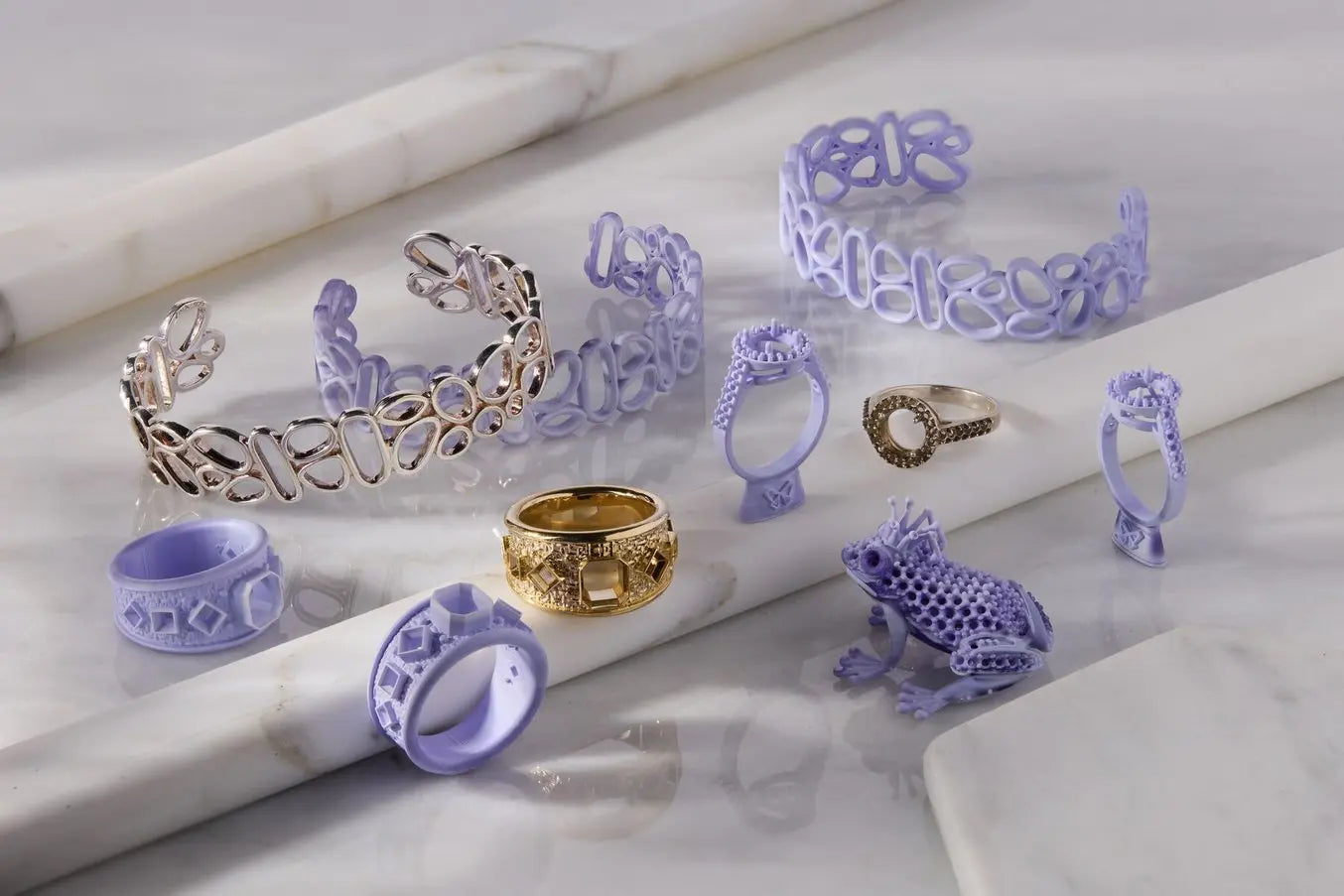 Image of finished jewelry pieces bangle fashion ring engagement ring next to wax jewelry model